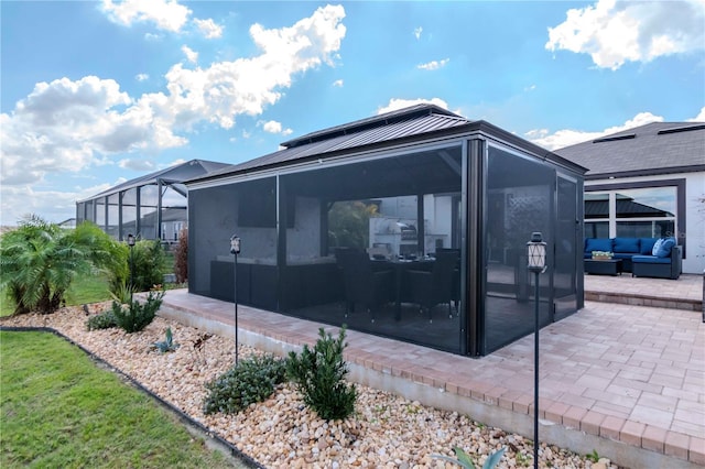 view of side of home with a patio and an outdoor hangout area