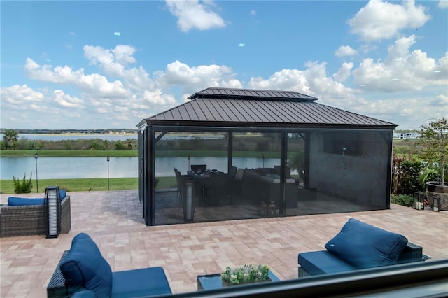 view of patio featuring a water view and an outdoor living space