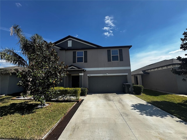 traditional-style home featuring a garage, a front yard, concrete driveway, and stucco siding