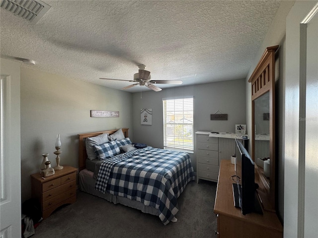 bedroom featuring carpet, visible vents, ceiling fan, and a textured ceiling