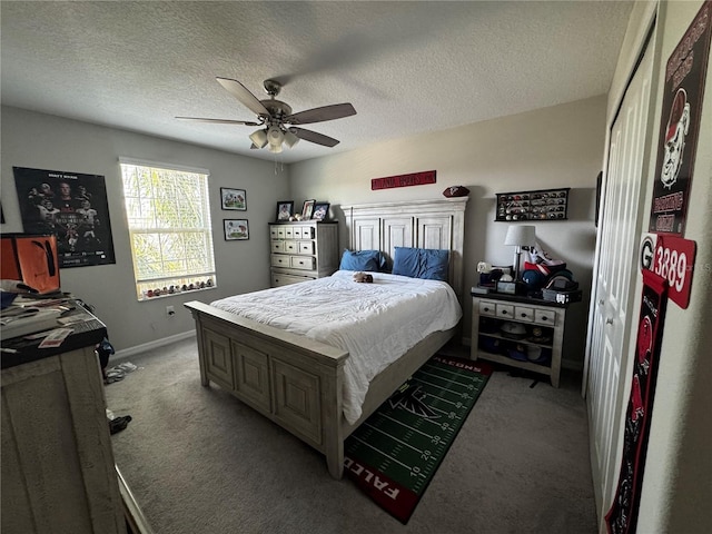 bedroom featuring a ceiling fan, baseboards, a textured ceiling, and light colored carpet