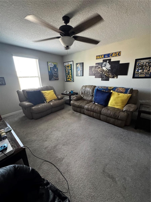 carpeted living area with ceiling fan and a textured ceiling