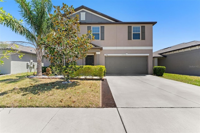 view of front of home with a front lawn, an attached garage, concrete driveway, and stucco siding