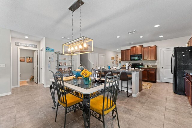 dining space with baseboards, a chandelier, visible vents, and recessed lighting