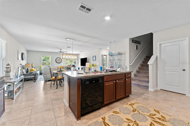 kitchen featuring open floor plan, a kitchen island with sink, light tile patterned floors, black dishwasher, and visible vents