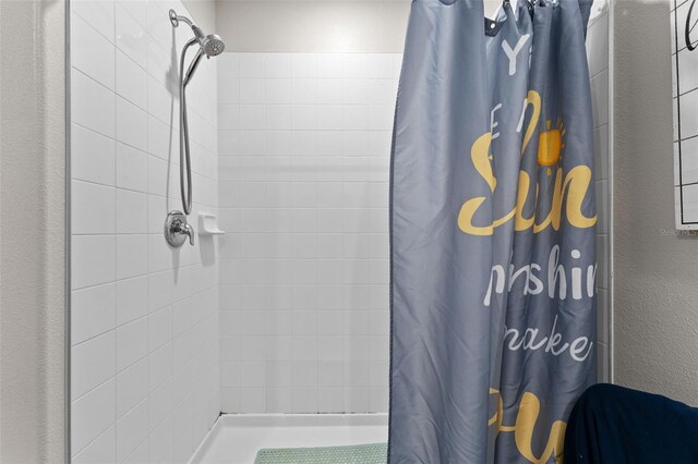 full bath with a tile shower