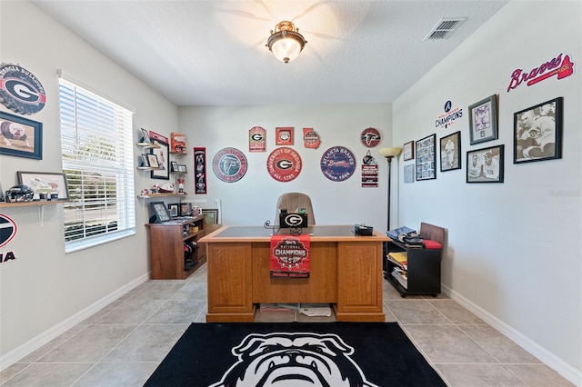 office area with baseboards, visible vents, and light tile patterned floors