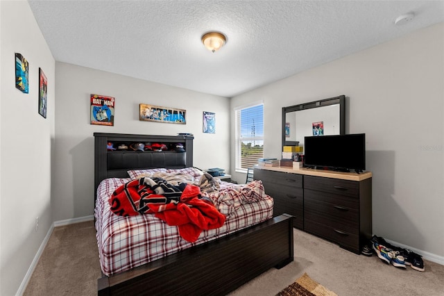 bedroom featuring baseboards, a textured ceiling, and light colored carpet