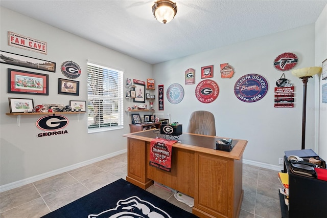 office space featuring baseboards, a textured ceiling, and light tile patterned floors
