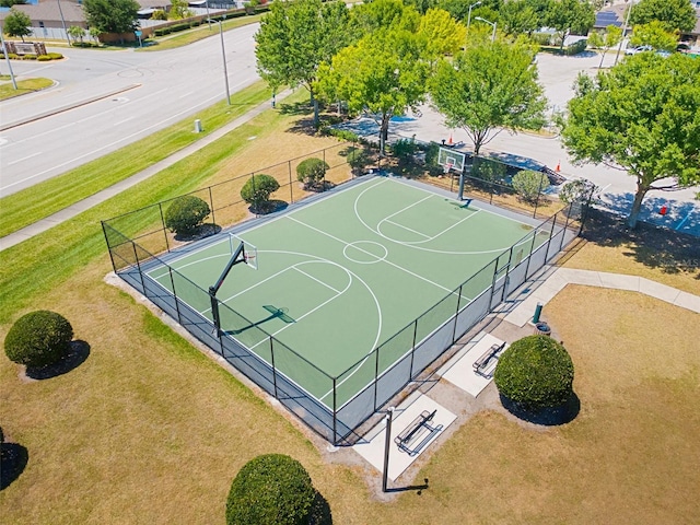 view of sport court featuring a yard, community basketball court, and fence
