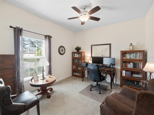 home office with carpet floors, ceiling fan, and baseboards