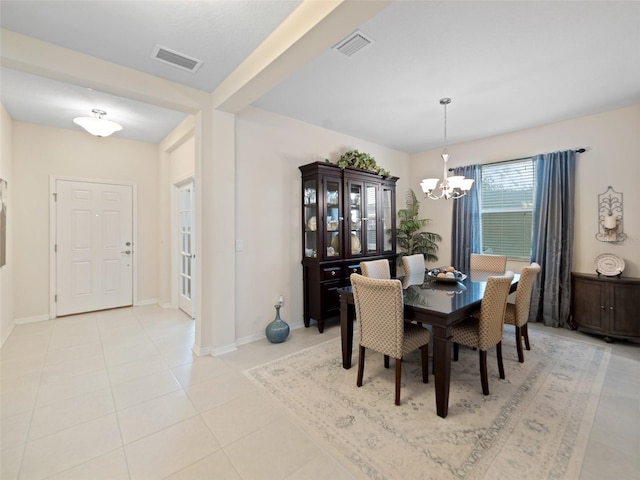 dining room with an inviting chandelier, baseboards, light tile patterned floors, and visible vents