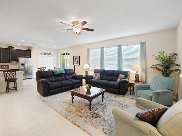 living area with a ceiling fan, recessed lighting, and light tile patterned flooring