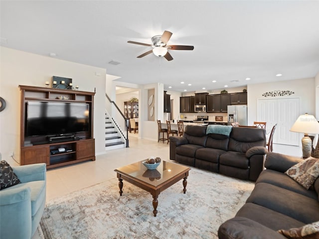 living area featuring light tile patterned floors, visible vents, stairway, and recessed lighting