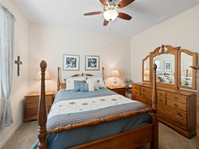 carpeted bedroom with baseboards, visible vents, and a ceiling fan