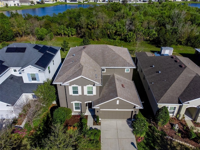 birds eye view of property with a water view and a residential view