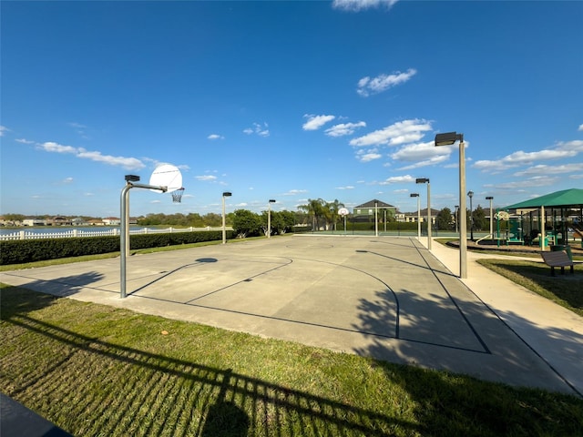 view of basketball court featuring playground community and community basketball court