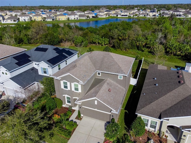 drone / aerial view featuring a water view and a residential view