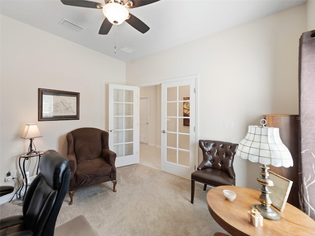 sitting room featuring carpet floors, french doors, visible vents, and a ceiling fan