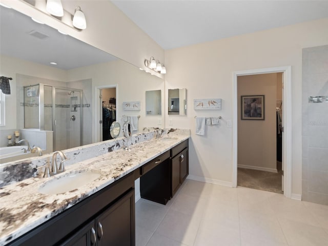 bathroom featuring visible vents, a spacious closet, a stall shower, vanity, and tile patterned floors