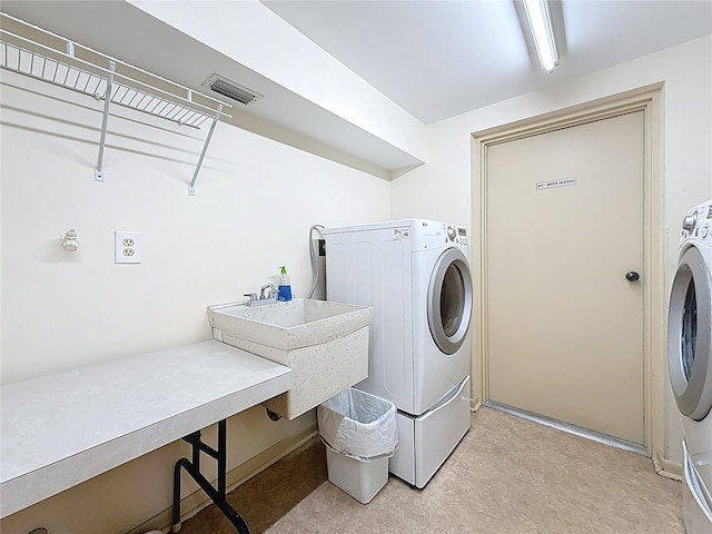 laundry area with a sink, visible vents, and laundry area