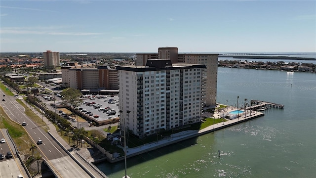 drone / aerial view featuring a water view and a view of city