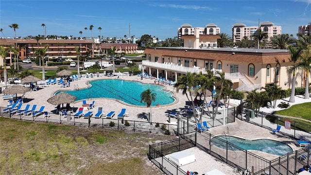 community pool featuring a patio area and fence