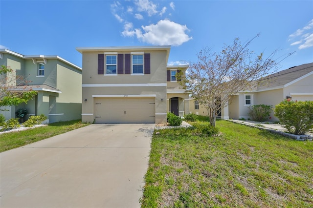 traditional-style home with an attached garage, concrete driveway, a front yard, and stucco siding