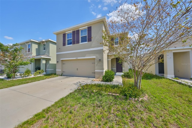 view of front of house with an attached garage, a front lawn, concrete driveway, and stucco siding