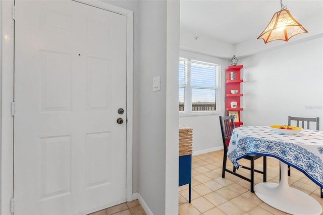 dining room with baseboards and light tile patterned floors