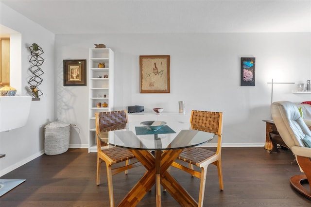 dining area featuring baseboards and wood finished floors