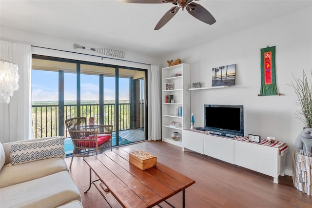 living room with wood finished floors and a ceiling fan