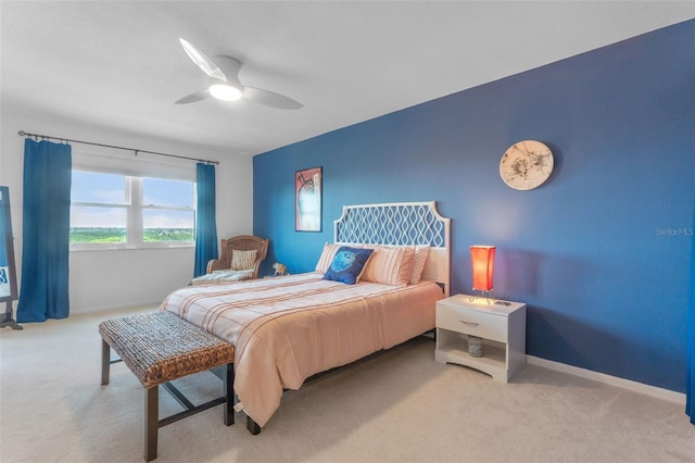 carpeted bedroom featuring ceiling fan and baseboards