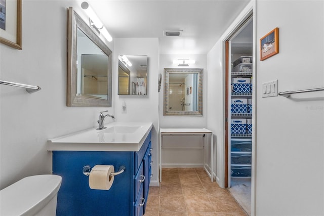 full bath with toilet, vanity, tile patterned flooring, and visible vents