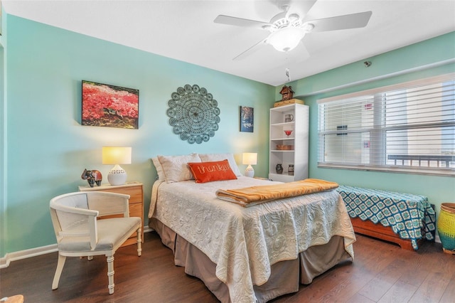 bedroom with ceiling fan, baseboards, and wood finished floors