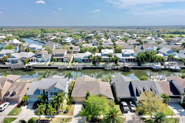 birds eye view of property featuring a water view and a residential view