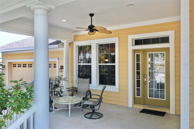 view of exterior entry featuring a ceiling fan, a patio area, and roof with shingles