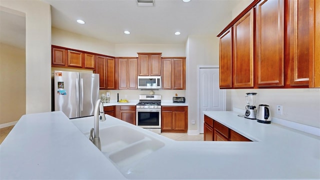 kitchen with appliances with stainless steel finishes, recessed lighting, light countertops, and visible vents