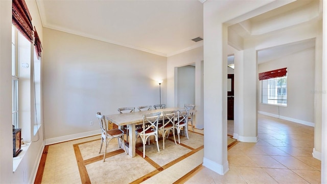 dining space featuring light tile patterned floors, visible vents, baseboards, and ornamental molding