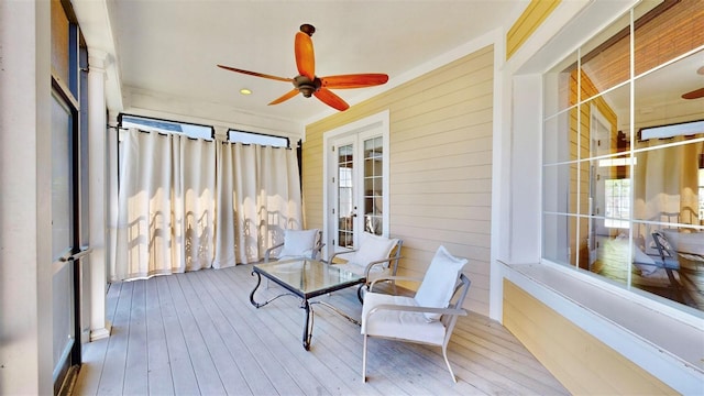 sunroom / solarium with ceiling fan and french doors