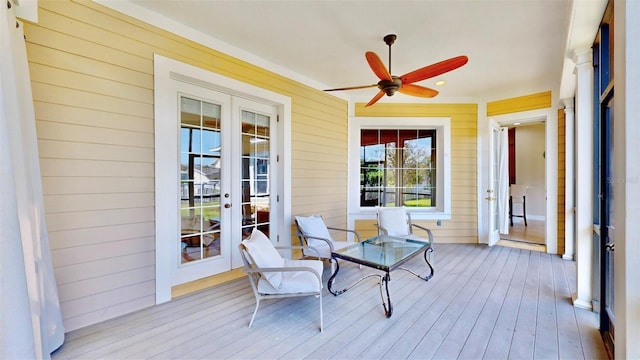 wooden terrace featuring a ceiling fan and french doors