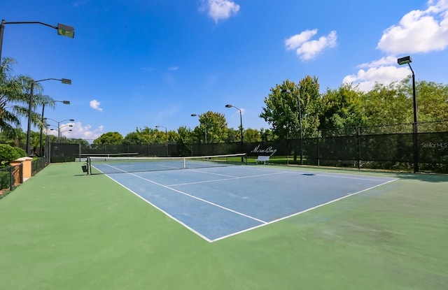 view of tennis court with fence