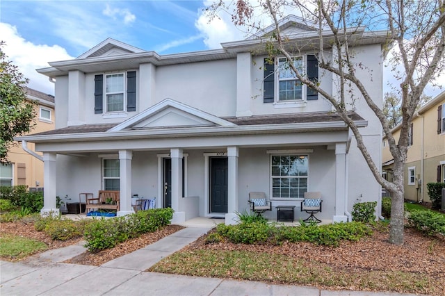 view of front of home featuring covered porch and stucco siding