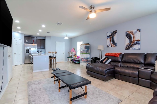 living room featuring a ceiling fan, recessed lighting, visible vents, and light tile patterned floors