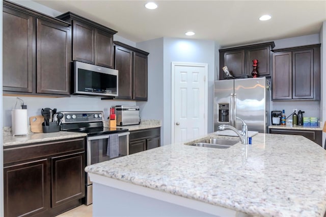 kitchen featuring appliances with stainless steel finishes, recessed lighting, a sink, and dark brown cabinets