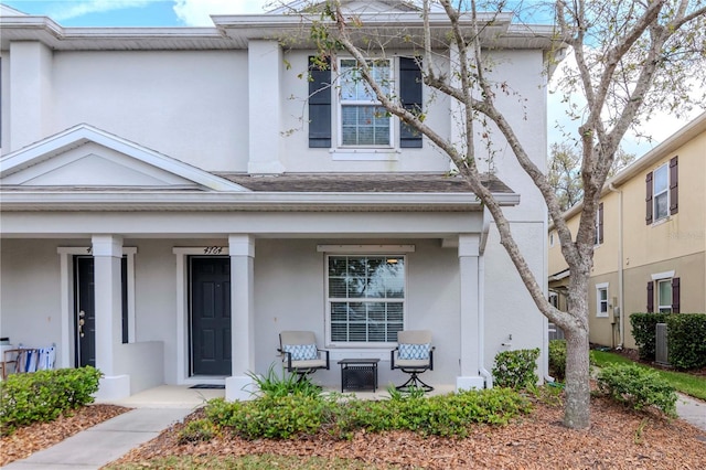 view of front of house featuring a porch and stucco siding