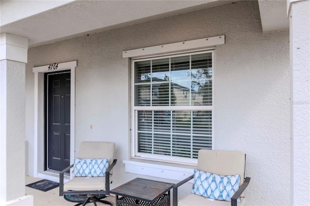 view of exterior entry featuring stucco siding