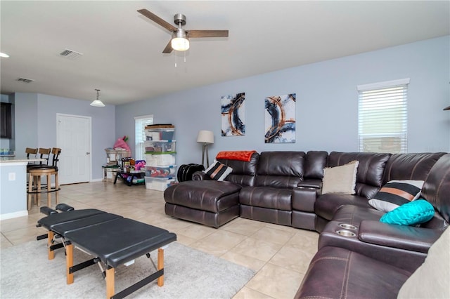 living area featuring visible vents, plenty of natural light, and light tile patterned floors