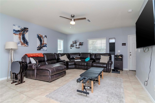 living room featuring visible vents, ceiling fan, baseboards, and light tile patterned flooring