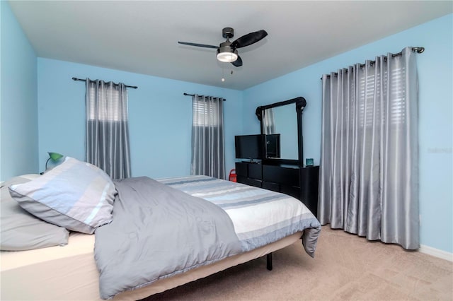 bedroom featuring light carpet and ceiling fan